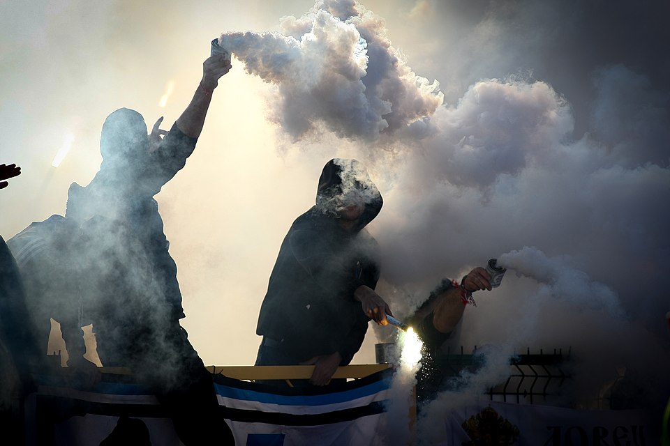 Hinchas siguiendo un partido con tensión en un bar deportivo